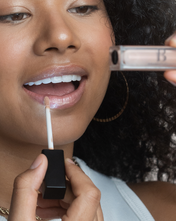lip gloss glitter with led light feature and mirror girl applying on lip