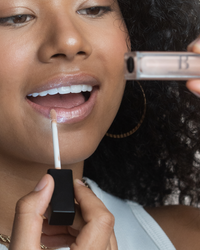 lip gloss glitter with led light feature and mirror girl applying on lip